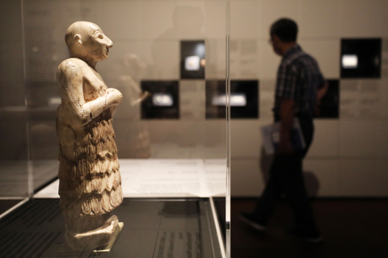 Votive Figurine of a man whose hands are clasped at his waist in a pious gesture. During this time, wealthy donors commissioned votives to be installed within temples as dedications to their gods. The figurine dates back to 2600-2350 BCE. [NEWS1]