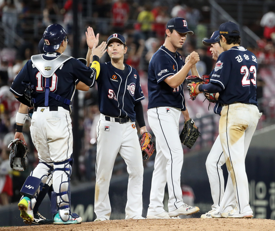 The Doosan Bears celebrate after beating the Kia Tigers 5-3 at Gwangju-Kia Champions Field in Gwangju on Friday. [YONHAP]