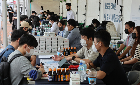 Students seeking for a job flood an annual job fair that was held face-to-face for the first time in three years hosted by the Busan National University on Thursday. [SONG BONG-GEUN]