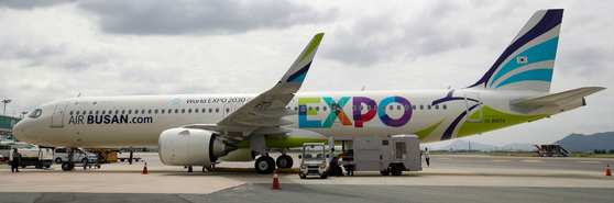 An Air Busan plane at the Gimhae International Airport in Busan Thursday is decorated to promote the city's bid to host the World Expo 2030. [NEWS1] 