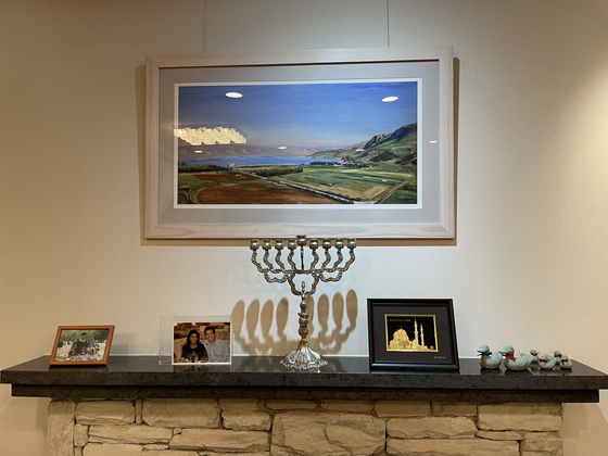 On top of a fireplace at the Israeli diplomatic residence in Seoul is a menorah and a gift from the U.A.E. embassy depicting the Grand Mosque of Abu Dhabi. [ESTHER CHUNG]