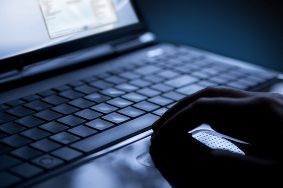 A person uses a laptop. [SHUTTERSTOCK]