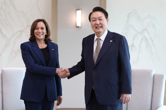 Korean President Yoon Suk-yeol, right, and U.S. Vice President Kamala Harris shake hands before talks at the Yongsan presidential office in central Seoul Thursday. [PRESIDENTIAL OFFICE]