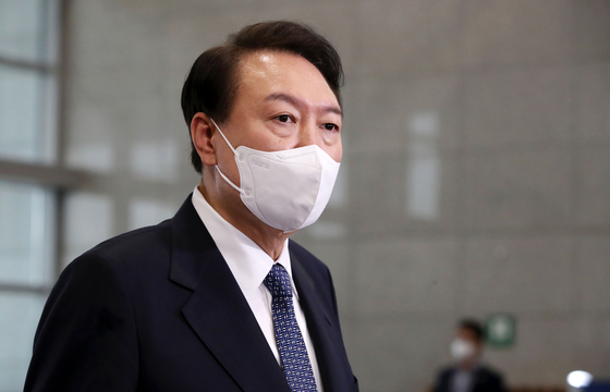 President Yoon Suk-yeol answers questions from reporters at the presidential office in Yongsan District, central Seoul, on Tuesday. [YONHAP]