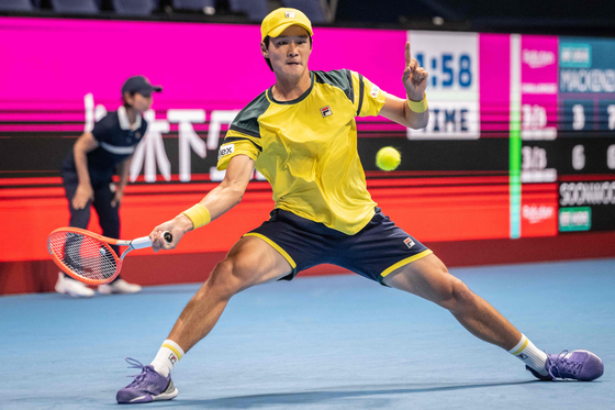Kwon Soon-woo lunges for the ball against Mackenzie McDonald of the United States during their men's singles round of 16 match at the Japan Open in Tokyo on Wednesday. [AFP/YONHAP]