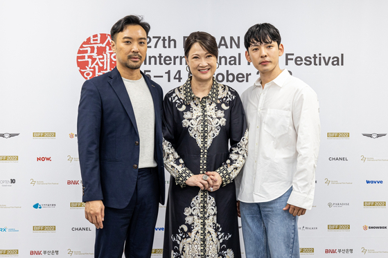 From left, director He Shuming, actors Hong Huifang and Kang Hyung-seok pose for a photo at a local press event at the Busan Visual Industry Center on Friday. [BIFF]