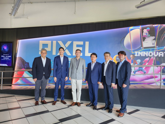 Officials from the Infocomm Media Development Authority (IMDA) and D.Camp stand for photos after signing an agreement on Tuesday at the Pixel start-up incubating center. [D.CAMP]