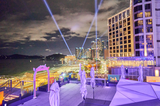 Outdoor lounge of Paradise Hotel Busan is lit up in BTS's signature color purple. [BIGHIT MUSIC]