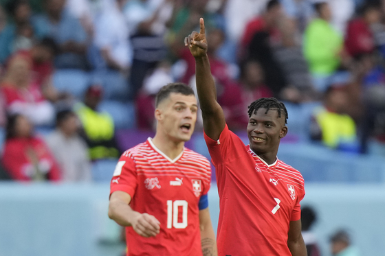 Switzerland's Breel Embolo, right, celebrates after scoring against Cameroon in a Group G match at the 2022 Qatar World Cup. Embolo, who was actually born in Cameroon before his family settled in Switzerland, provided the only goal in the 1-0 win at Al Janoub Stadium in Al Wakrah, Qatar on Thursday.  [AP/YONHAP]