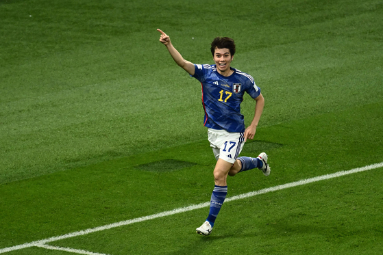 Japan's midfielder Ao Tanaka celebrates scoring his team's second goal with his teammates during the Qatar 2022 World Cup Group E football match between Japan and Spain at the Khalifa International Stadium in Doha on Thursday. [AFP/YONHAP]