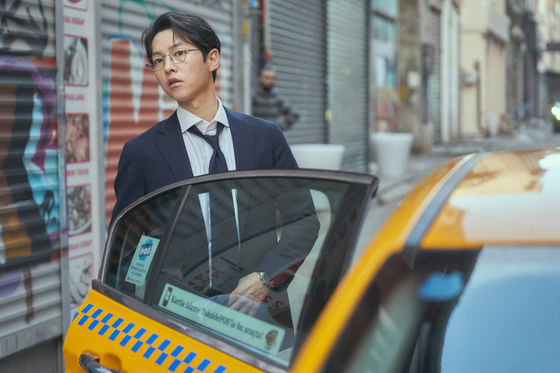 Song Joong-ki portrays Hyun-woo, above, an employee of Soonyang Group who is betrayed and murdered by his company. After his death, he is reincarnated as Do-jun, the youngest grandson of the Soongyang family. Song also portrays the adult version of Do-jun. [JTBC]