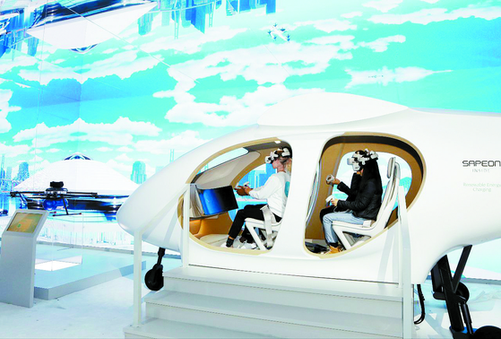 Visitors experience SK Telecom's urban air mobility at the CES 2023 in Las Vegas, Nevada, on Tuesday, two days ahead of the opening of the world's largest consumer electronics show. [SK INC.]
