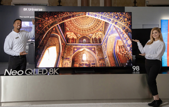 Models pose with the new 98-inch Neo QLED model Tuesday in Las Vegas. [SAMSUNG ELECTRONICS]