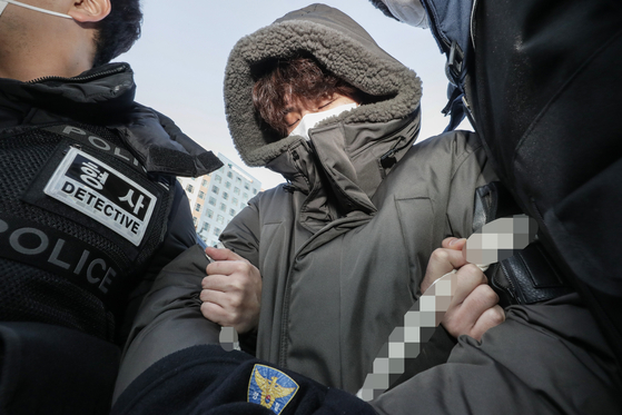 Murder suspect Lee Ki-young is escorted by the police in Ilsan, Gyeonggi, on Wednesday before getting on a van to the prosecutors' office. [YONHAP]