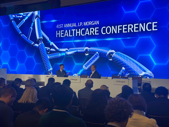 Biogen CEO Christopher Viehbacher, right, speaks during the J.P. Morgan Healthcare Conference on Jan. 9 in San Francisco. [JOINT PRESS CORPS]