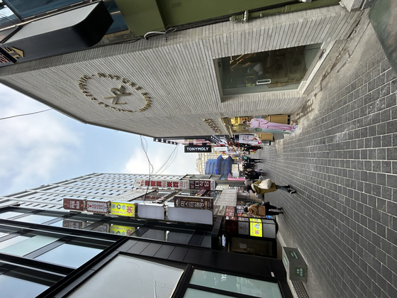 An alleyway in Myeongdong, central Seoul, aligned with local cosmetics brands stores, including Nature Republic and Tony Moly. [SHIN MIN-HEE]
