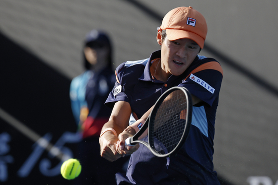 Kwon Soon-woo plays a backhand return to Christopher Eubanks during their first round match at the Australian Open tennis championship in Melbourne, Australia on Monday.  [AP/YONHAP]