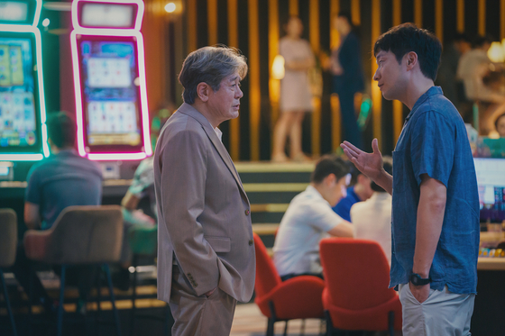 Choi Min-sik, left, as protagonist Cha Mu-sik in "Big Bet" [DISNEY+]
