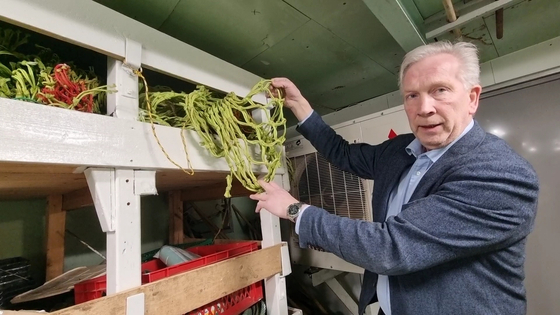 Roger B. Larsen holds a net used for large fish such as trout on research vessel Helmer Hanssen on Feb. 3. [SHIN HA-NEE]  