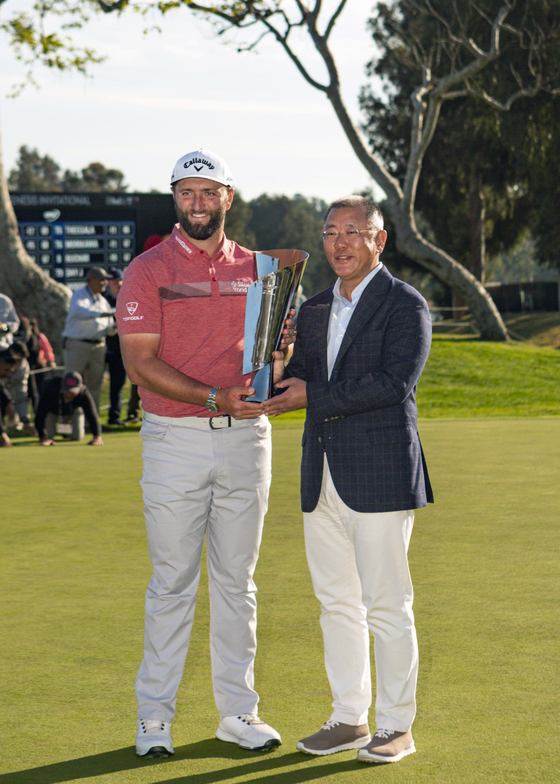 Hyundai Motor Group Executive Chair Euisun Chung, right, poses with Jon Rahm, winner of 2023 The Genesis Invitational, at the Riviera Country Club in Los Angeles on Feb. 19.  [HYUNDAI MOTOR]