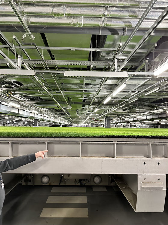 The side of the Tottenham Hotspur football pitch stored in the ″pitch pocket″ is visible during a tour of Tottenham Hotspur Stadium in London on Dec. 5.  [JINSIL YU]