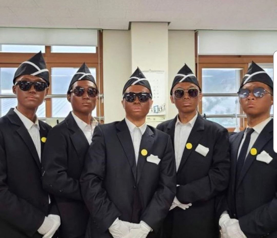 Sam Okyere was criticized for speaking out against a group of high school students, pictured, who painted their faces black to mimick the ″Coffin Dance″ video in 2020. [SCREEN CAPTURE]