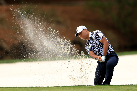 Kim Si-woo plays a shot from a bunker on the seventh hole during the first round of The Players Championship on The Players Stadium Course at TPC Sawgrass in Ponte Vedra Beach, Florida on Thursday.  [GETTY IMAGES]