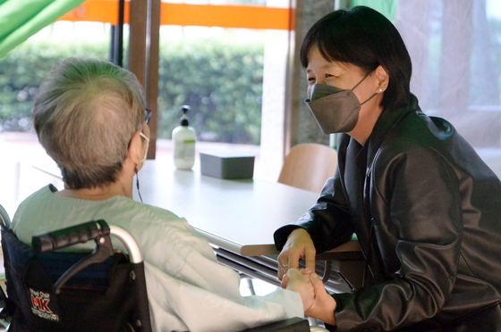 A patient at a nursing hospital in Gwangju meets with a visitor in October last year. [NEWS1]