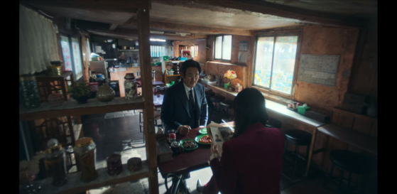 Gil Bok-soon (Jeon Do-yeon) and Cha Min-kyu (Sol Kyung-Gu) share a conversation in the old restaurant, Cheolgil Tteokbokki. [NETFLIX]
