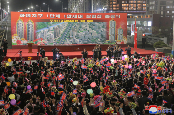 North Korean Leader Kim Jong-un celebrates in a groundbreaking ceremony for constructing 10,000 houses in Pyongyang on Sunday. [KOREAN CENTRAL NEWS AGENCY]