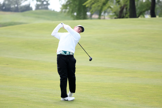 Robert MacIntyre of Scotland hits his second shot on the third hole during the Korea Championship Presented by Genesis at the Jack Nicklaus Golf Club Korea in Incheon on Saturday. [GETTY IMAGES]