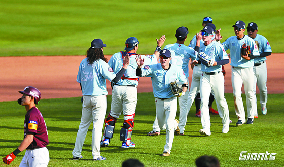The Lotte Giants celebrate after beating the Kiwoom Heroes 5-3 at Sajik Baseball Stadium in Busan on Sunday.  [LOTTE GIANTS]