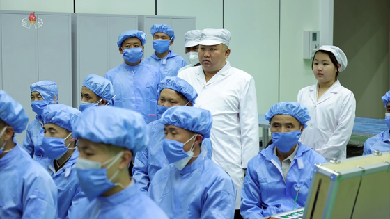 North Korean leader Kim Jong-un, center, inspects the country's first military reconnaissance satellite on Tuesday. [KOREAN CENTRAL NEWS AGENCY]