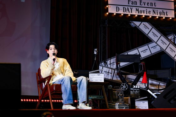 BTS member Suga talks with fans during his ″Agust D ‘D-DAY: Movie Night'″ meet and greet held Saturday in western Seoul. [BIGHIT MUSIC]