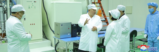 North Korean leader Kim Jong-un, center, inspects the country's first military reconnaissance satellite on May 16. [KOREAN CENTRAL NEWS AGENCY]