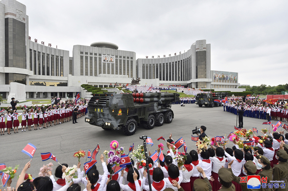 Multiple rocket launchers donated by the Korean Children's Union moving along outside the Mangyongdae Children's Palace in Pyongyang on Tuesday. [KOREAN CENTRAL NEWS AGENCY]