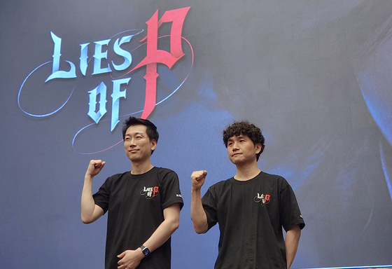 Jason Park, director at Studio 8, left, and Choi Ji-won, directing producer of Lies of P, pose for a photo after a press event to introduce Neowiz’s role-playing game (RPG) at Josun Palace Hotel in southern Seoul on Friday. [YONHAP] 