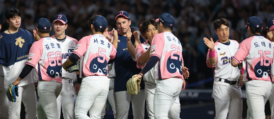 The NC Dinos celebrate after beating the SSG Landers 8-4 at Changwon NC Park in Changwon, South Gyeongsang on Sunday. The Dinos played Sunday's game wearing special ″Doguri″ uniforms bearing the image of the character owned by club owner NCSoft.  [YONHAP]
