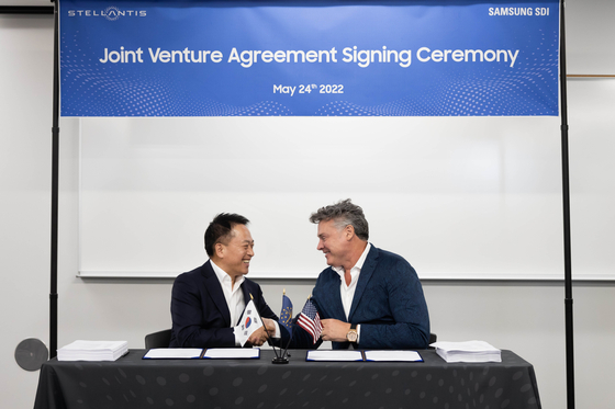 Samsung SDI CEO Choi, left, and Mark Stewart, Stellantis chief operating officer for the North American region, shake hands after signing an agreement to invest $2.5 billion in building an EV battery factory in Kokomo, Indiana, on May 24, 2022. [SAMSUNG SDI]