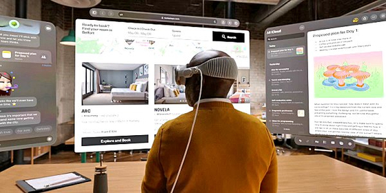 A user puts up virtual screens wearing Apple's Vision Pro. [APPLE]