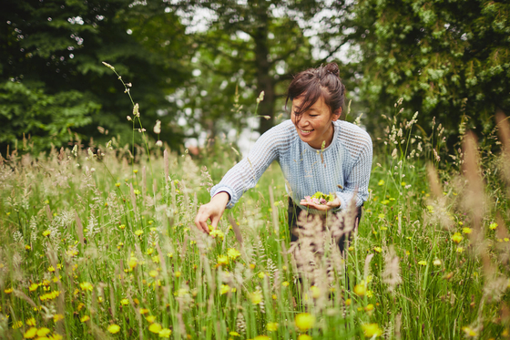 Ae Jin Huys collects edible herbs and flowers in Belgium to recreate Korean namul (seasoned greens). [GILLES DESPLANQUE]