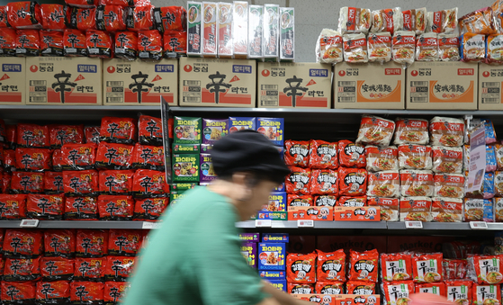 A customer shops for groceries at a supermarket in Seoul on Sunday. [YONHAP]