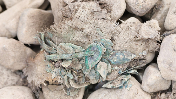 Gilt-bronze ornaments made using jewel beetle wings attached to different types of fabrics and a woven bamboo frame was excavated from tomb No.44 at Jjoksaem in Gyeongju.  [GNIRCH]
