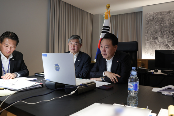 South Korean President Yoon Suk Yeol speaks at a National Security Council meeting convened at 5:45 a.m. on Wednesday in Vilnius, Lithuania in response to the long-range missile launch by North Korea. Yoon is attending the annual NATO summit in Vilnius as an observer.