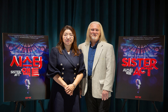 Vice President and Producer of EMK Musical Company Sophy Kim, left, and director Robert Johanson pose for photos before speaking to the press in Gangnam District, southern Seoul, on Monday. [EMK MUSICAL COMPANY]