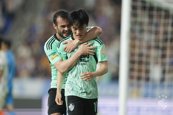 Ulsan Hyundai's Um Won-sang, front, celebrates with Valeri Qazaishvili after scoring a goal during a K League game against Jeonbuk Hyundai Motors at Ulsan Munsu Football Stadium in Ulsan in a photo shared on Ulsan's official Facebook page on Sunday. [SCREEN CAPTURE] 