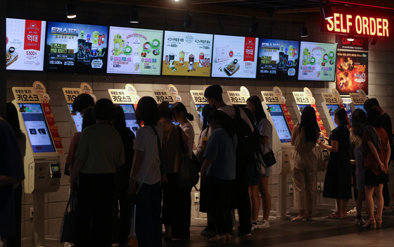 Theatergoers buy tickets at a multiplex in central Seoul on July 2, 2023. [YONHAP]