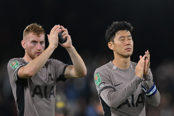 Tottenham Hotspur's Son Heung-min, right, and Dejan Kulusevski applaud at the end of a Carabao Cup match between Fulham and Tottenham at Craven Cottage in London on Tuesday.  [AFP/YONHAP]