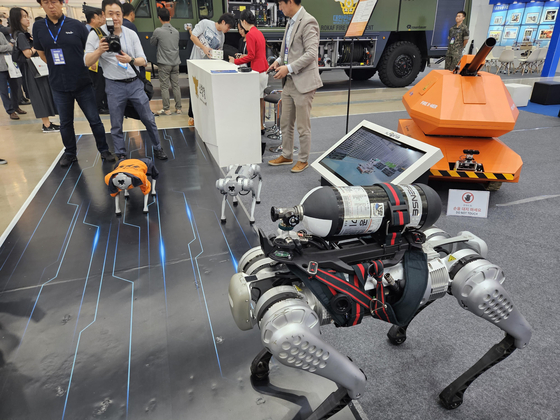 A four-legged robot developed by Young In Mobility carries a fire extinguisher at the company's booth at the International Fire & Safety Expo Korea 2023 in Daegu on Wednesday. [YONHAP]