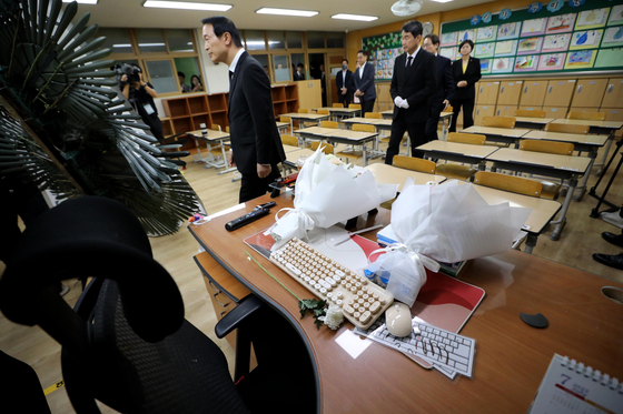 Education Minister Lee Ju-ho, second in line, on Monday walks through the classroom, which the Seo 2 Elementary School teacher, who committed suicide in July, used to teach first graders. [NEWS1]